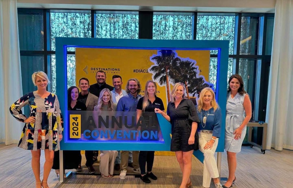 A group of professionals posing behind a 2024 Annual Convention photo frame
