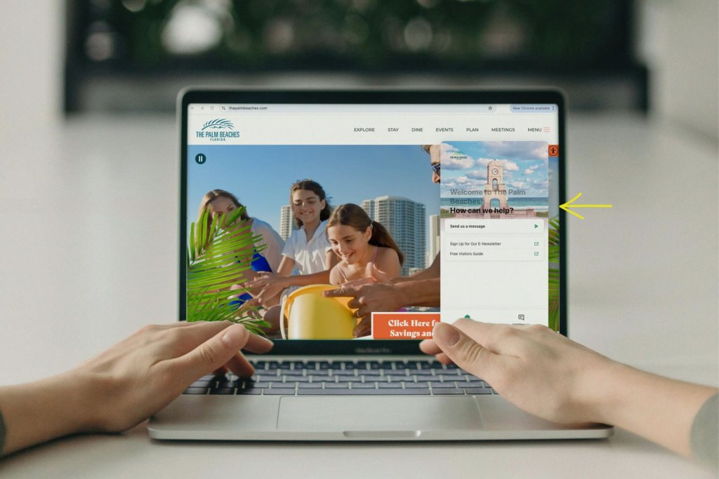 A person using a laptop to view The Palm Beaches travel website