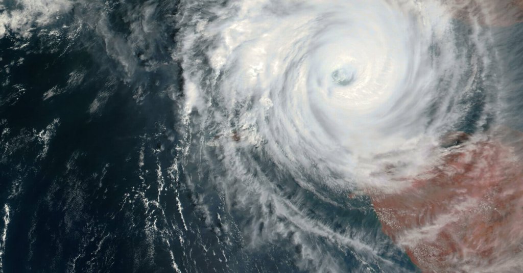 A satellite view of a large, swirling tropical cyclone over the ocean