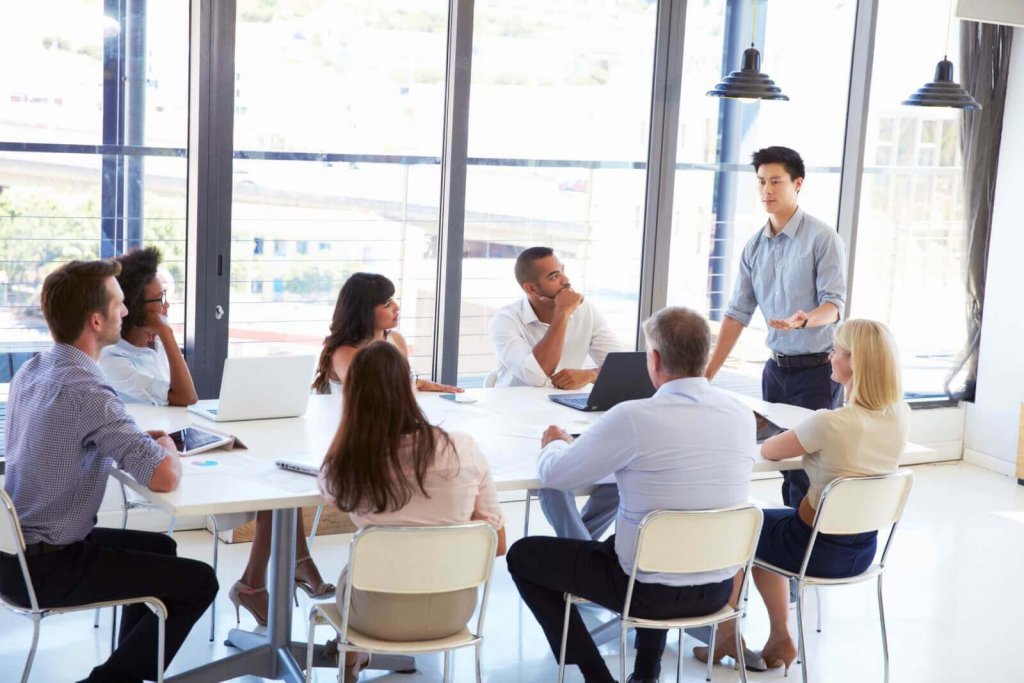 A diverse group of professionals sitting around a table during a business meeting