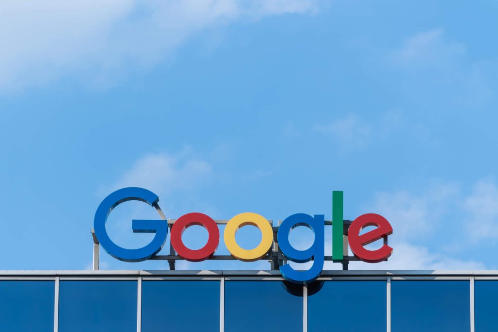 The colorful Google logo mounted on top of a modern office building