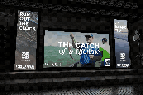 A stage with three screens displaying Port Aransas advertisements, including a man fishing