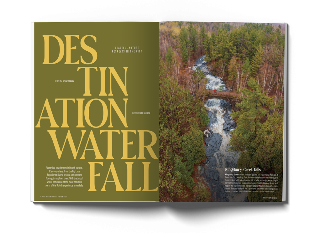 A magazine spread featuring a large waterfall flowing through a forest with a bridge