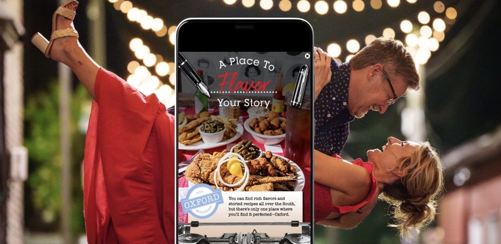 A smartphone displays a food advertisement over a couple dancing in the background