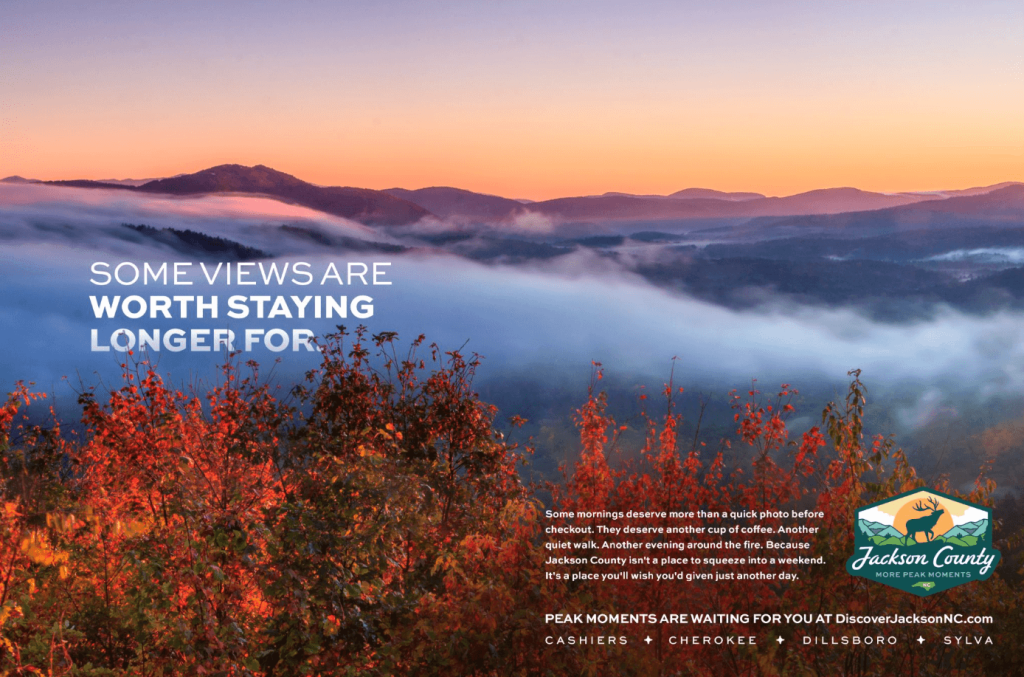 A scenic mountain landscape at sunrise with fog over the valley and autumn foliage