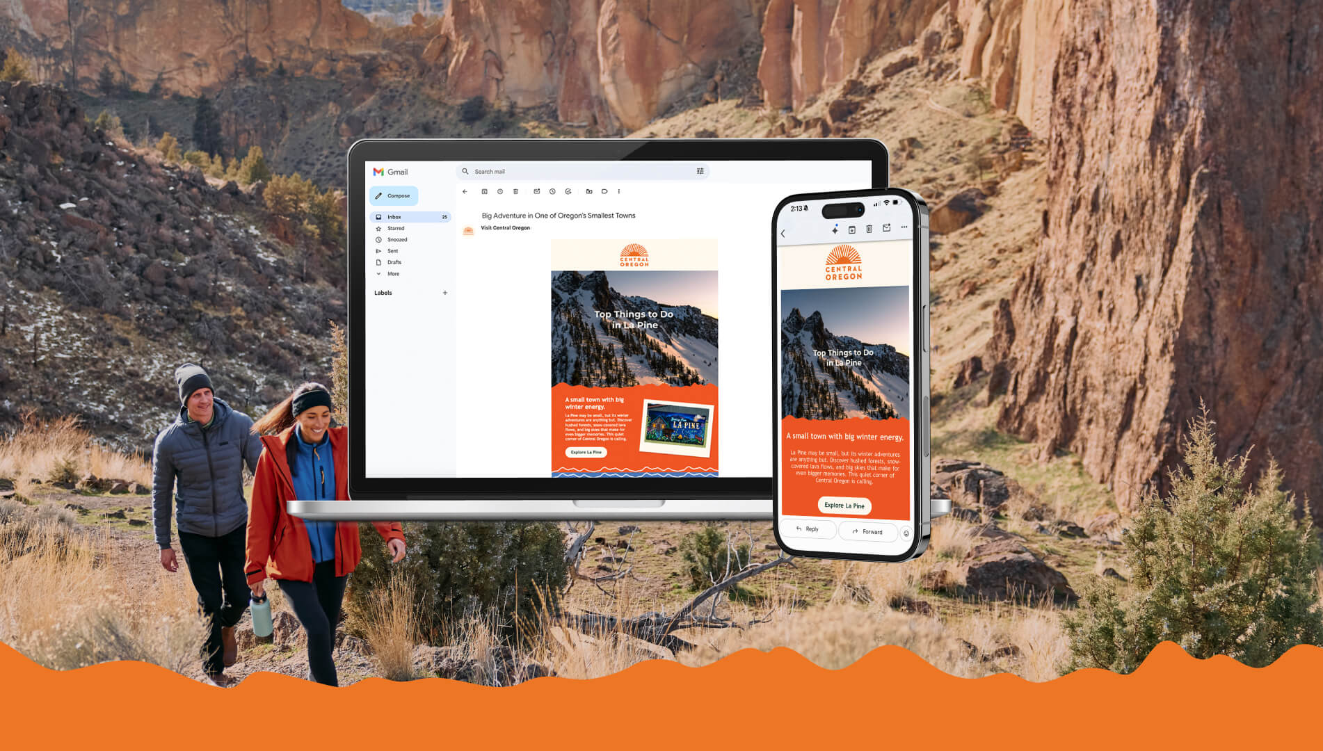 A couple hiking in a rocky landscape with a laptop and phone displaying emails