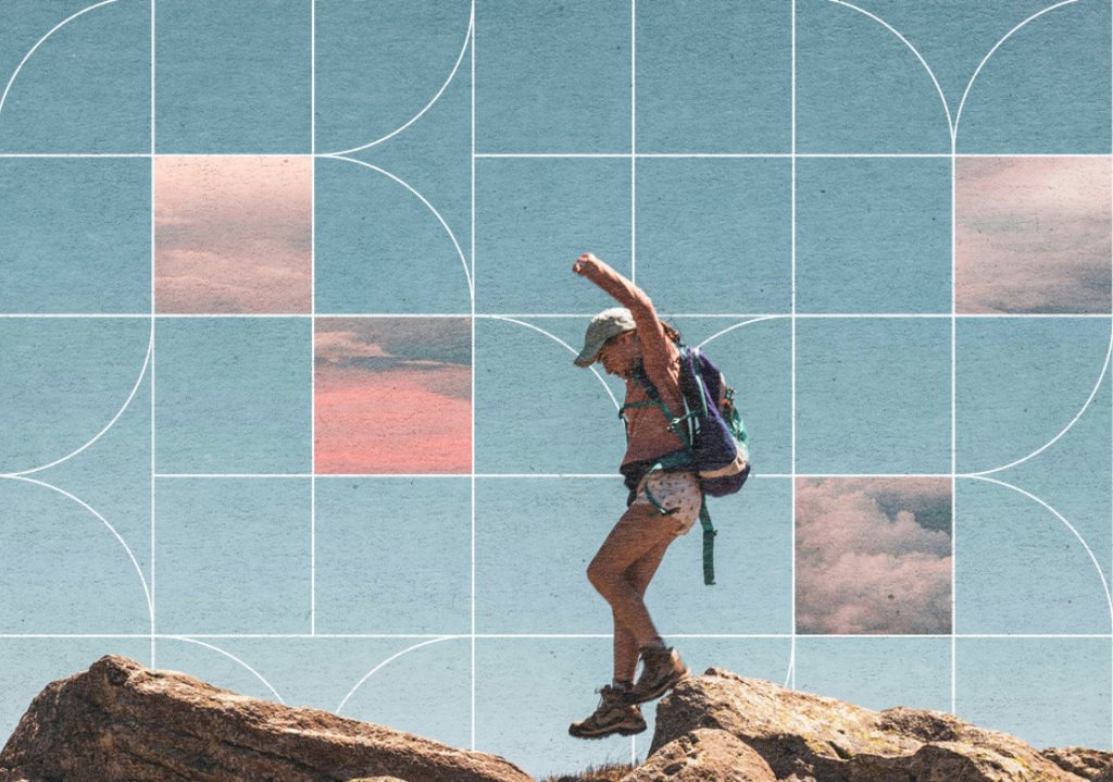 A person with a backpack and hat jumps between rocks against a geometric sky