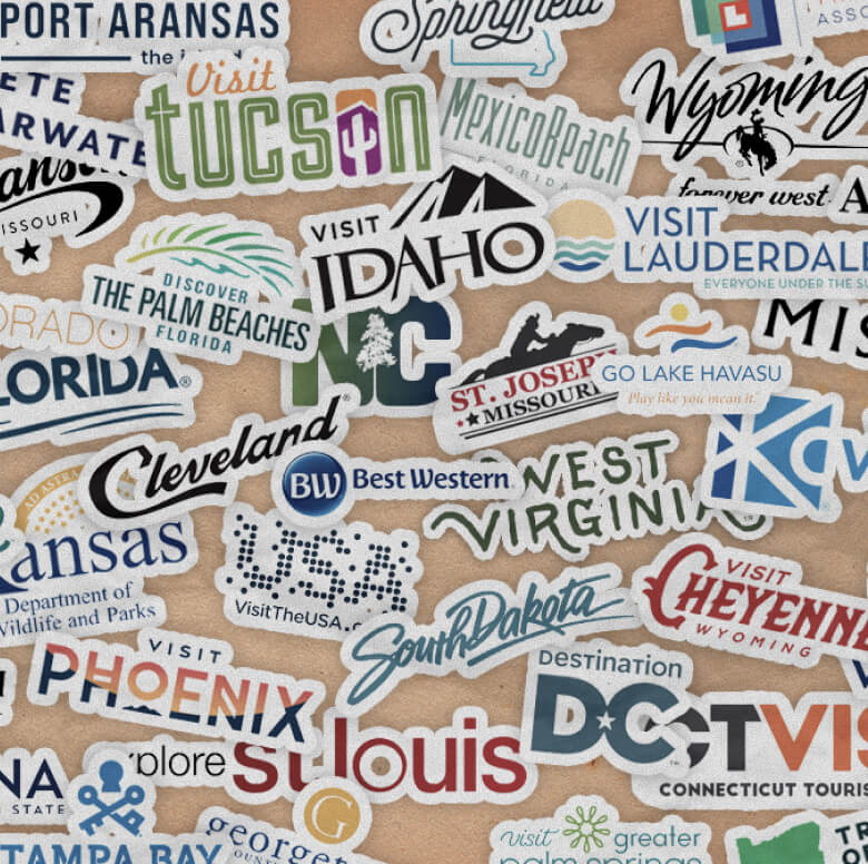 A collection of travel stickers for various US cities and states