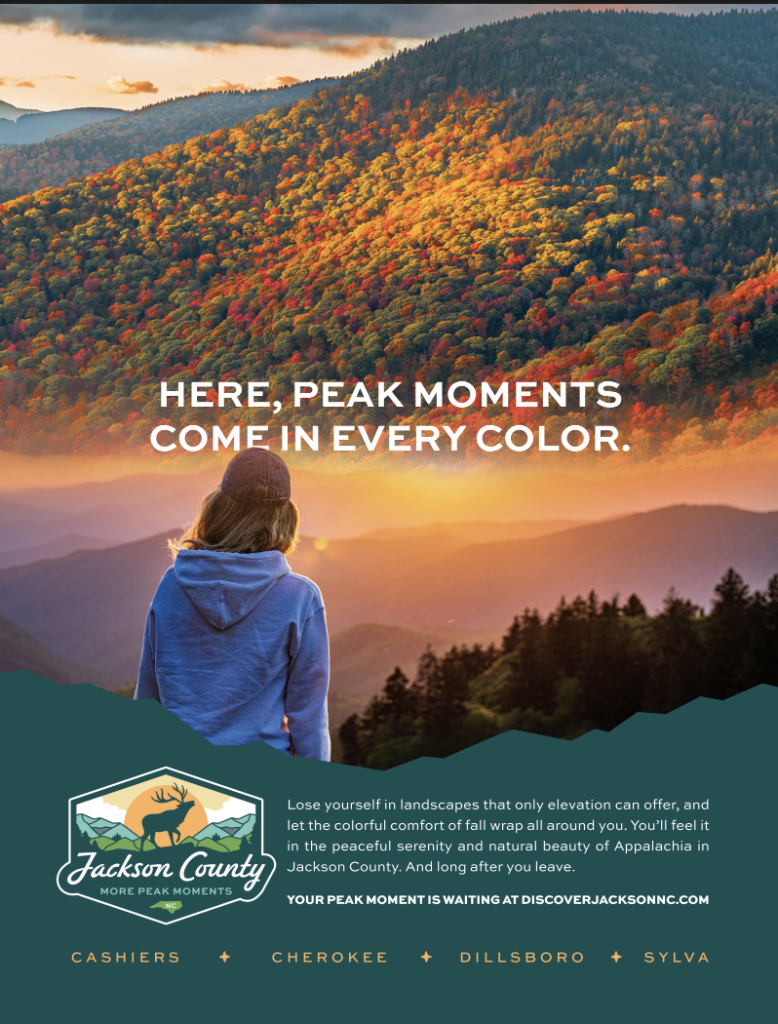 A person views a vibrant autumn mountain landscape at sunset